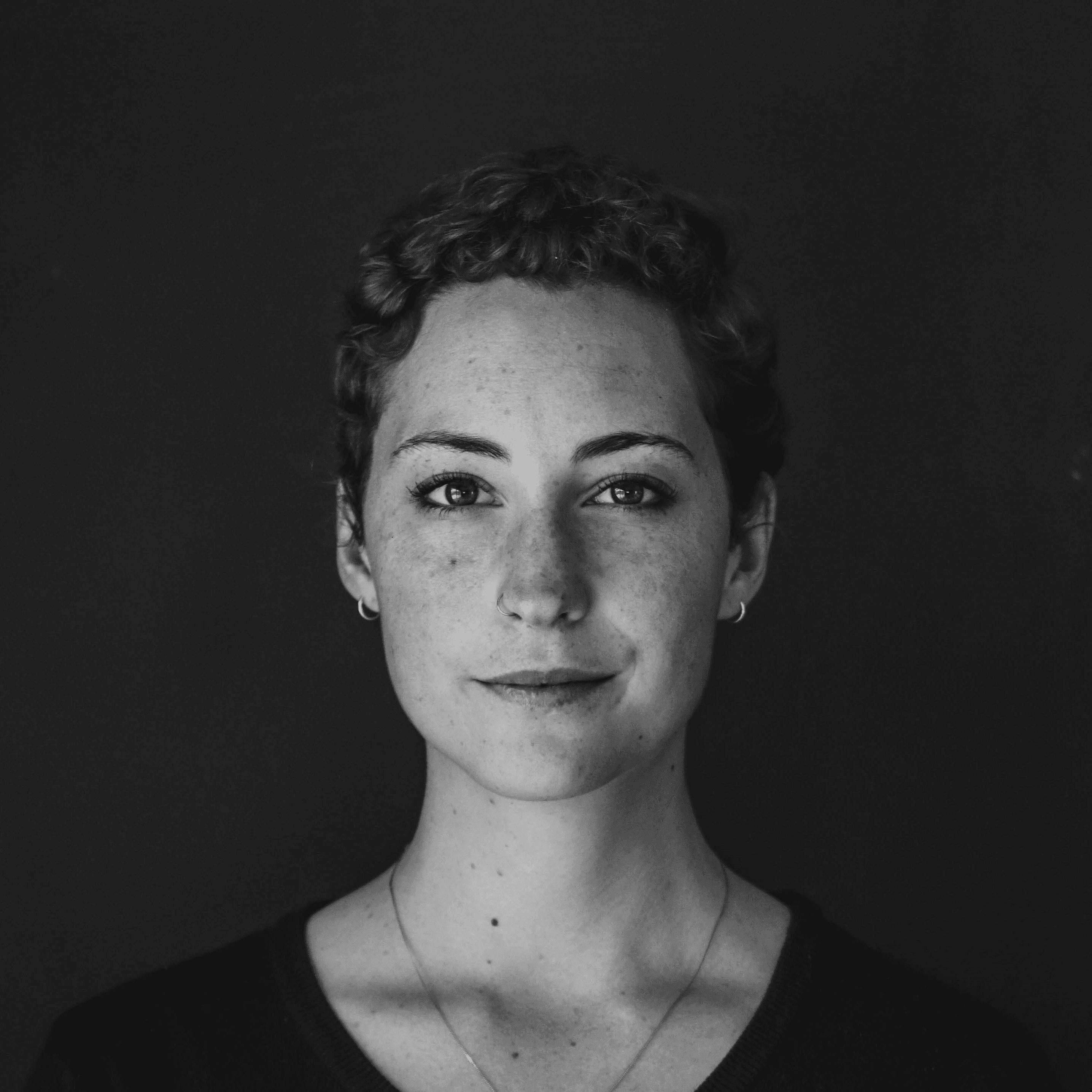 grayscale photo of woman wearing necklace and top