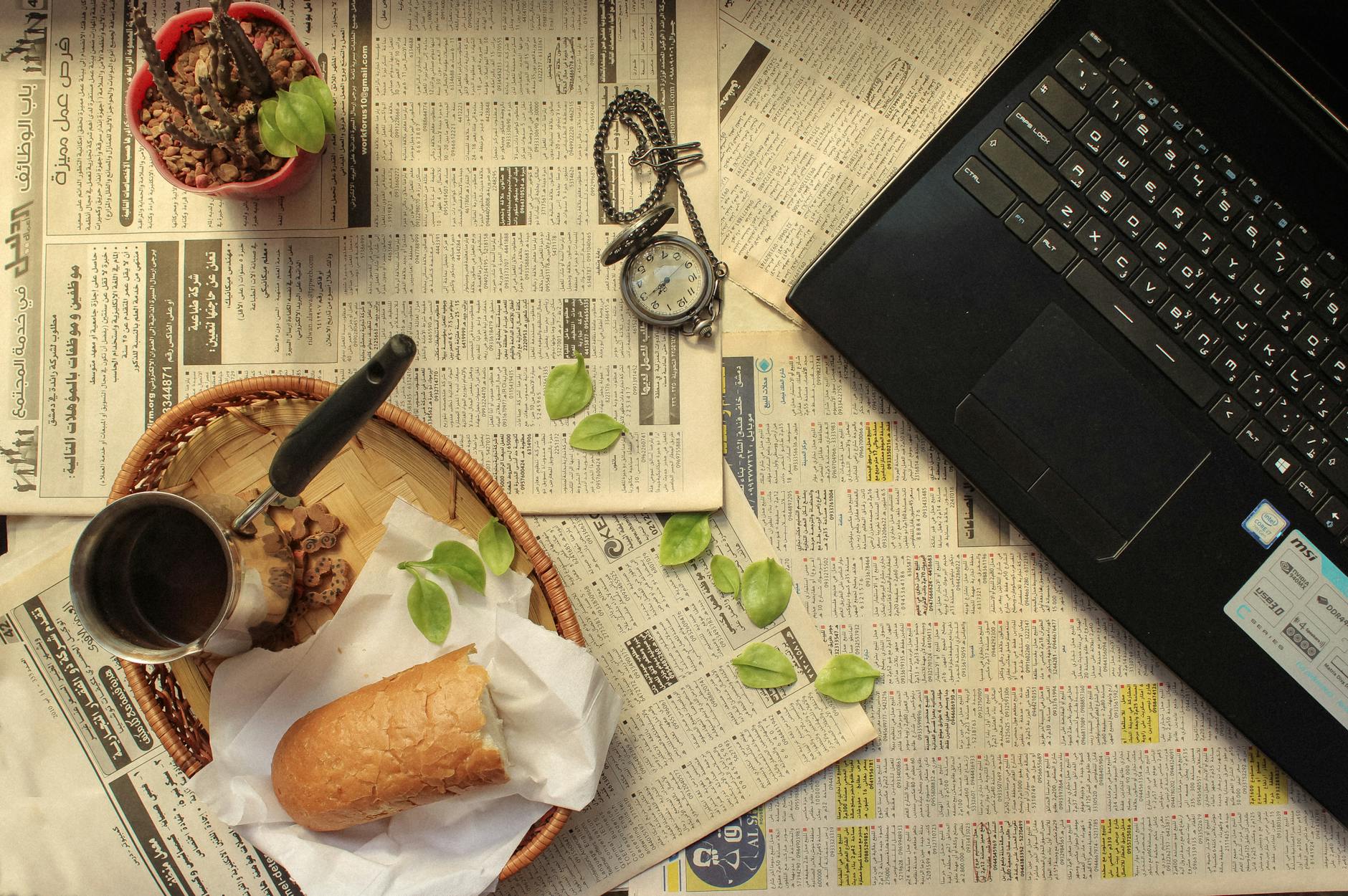 A teacher pointing to a digital news article on a screen while discussing a history lesson with high school students.
