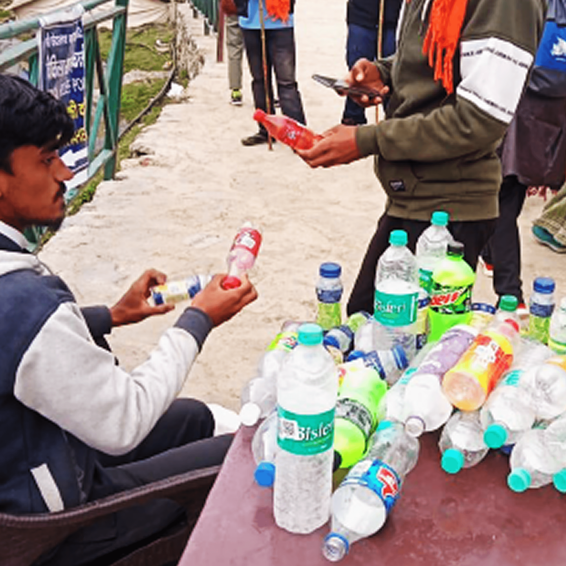 Woman in red outfit poses by a red telephone booth.