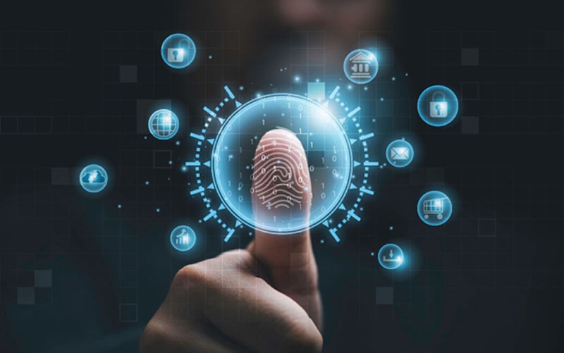 A person walks in front of large stone arches with dark doors, flanked by tall columns, in a historic building.