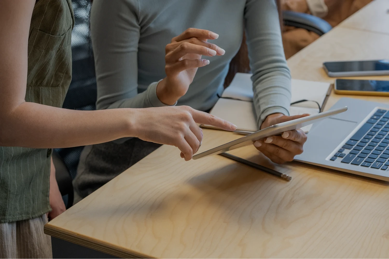 Two women working on a tablet