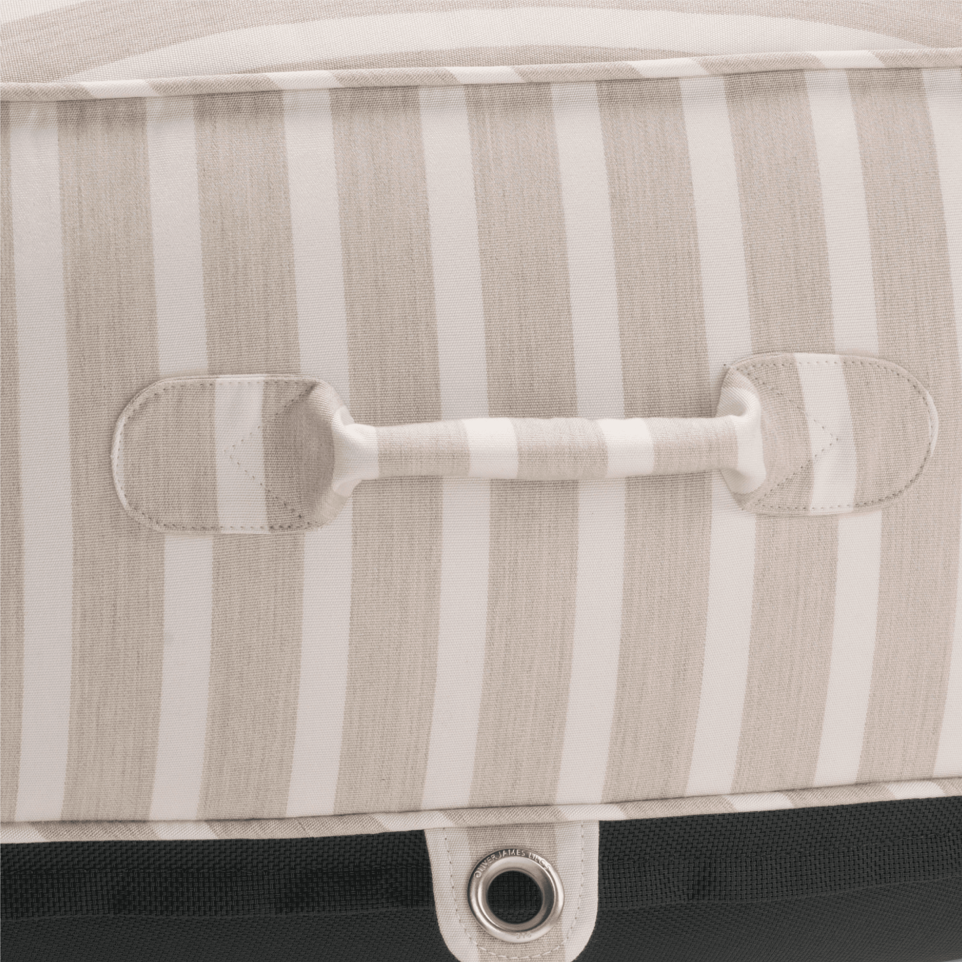 Close-up of a pool float with beige-stripe canvas handle, topstitched seams, and silver stainless eyelet