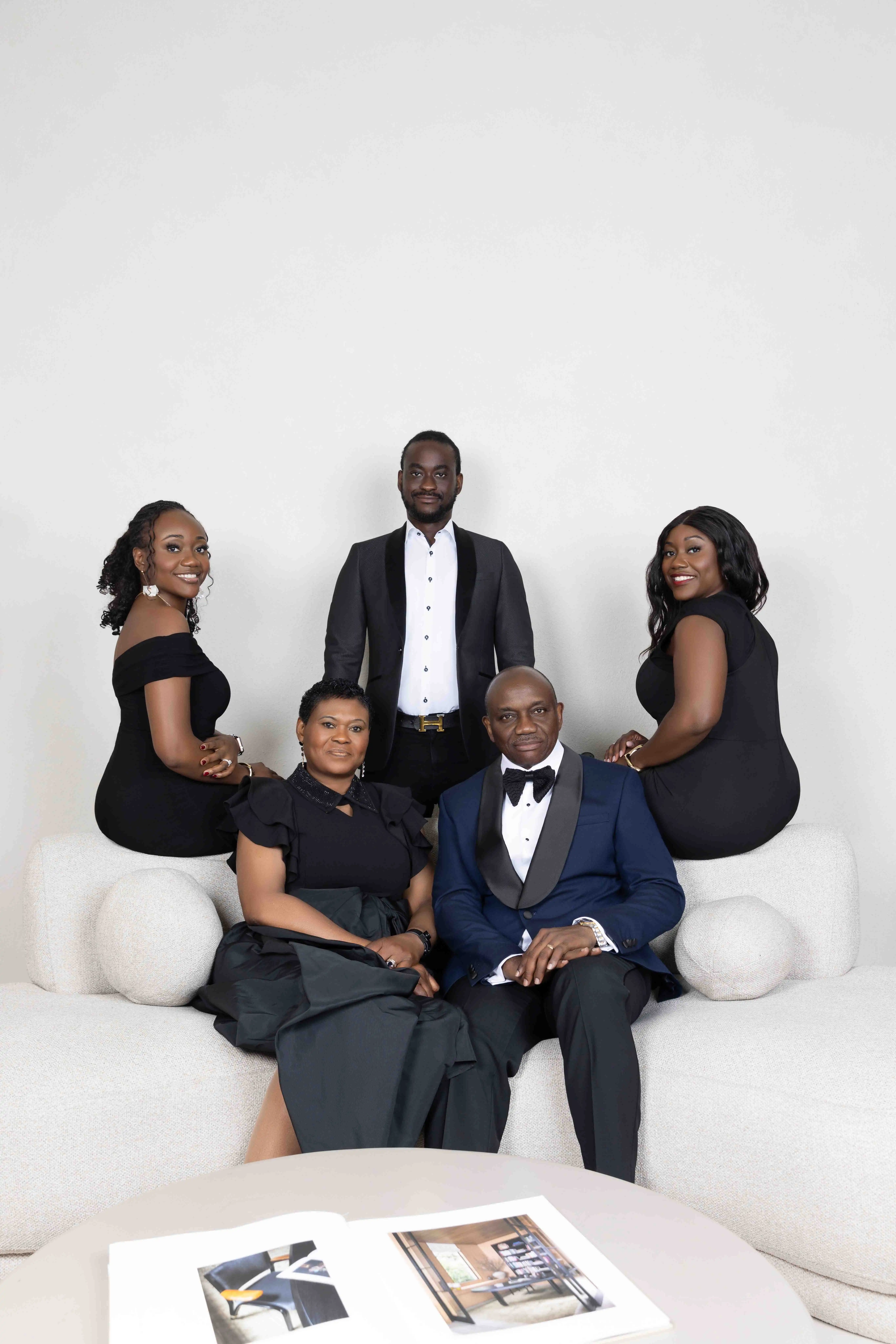 Studio family portrait of five in black and white outfits