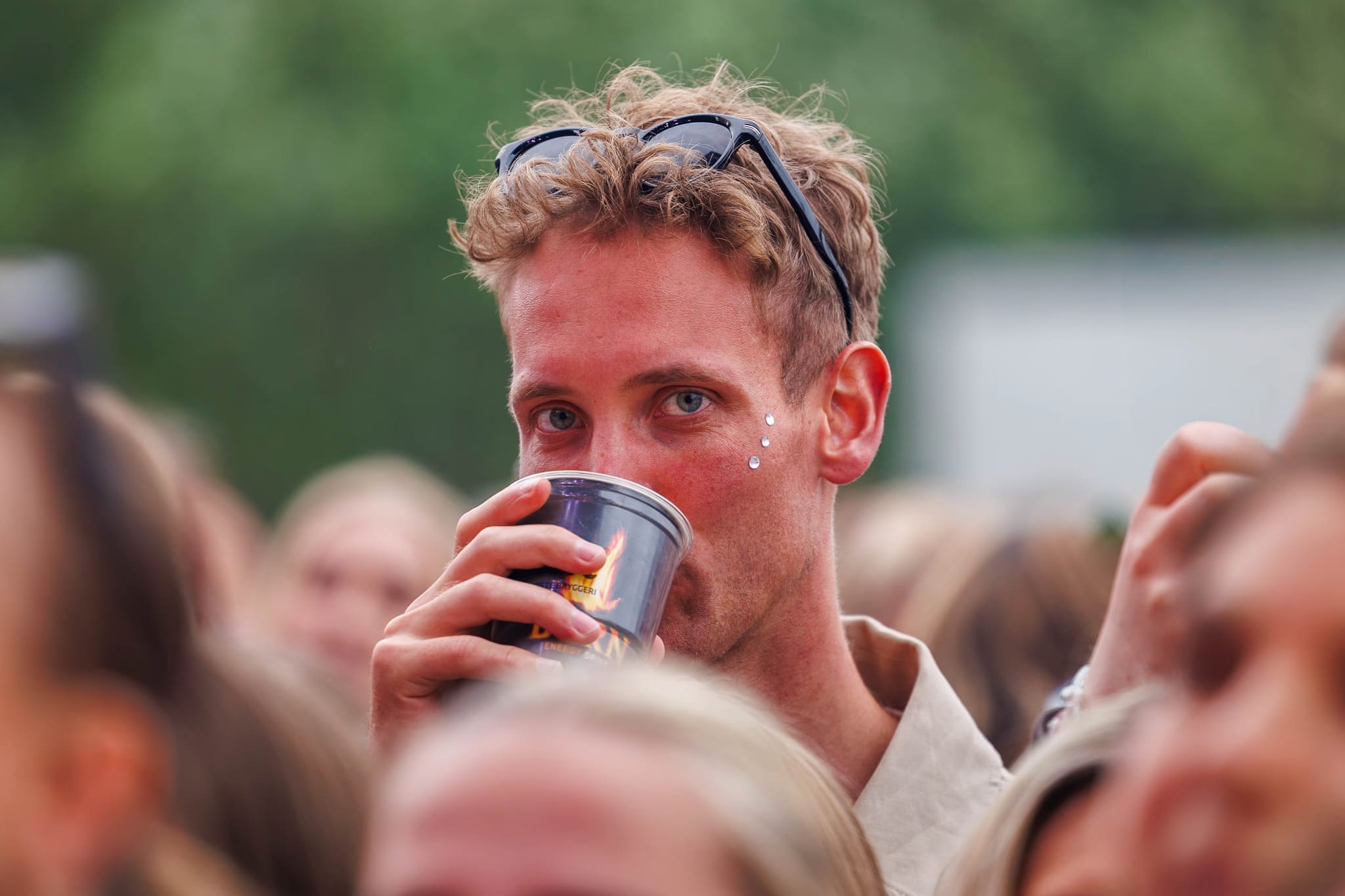 person drinking burn energy during the NEON Festival in Trondheim last year covred by Flyby Media