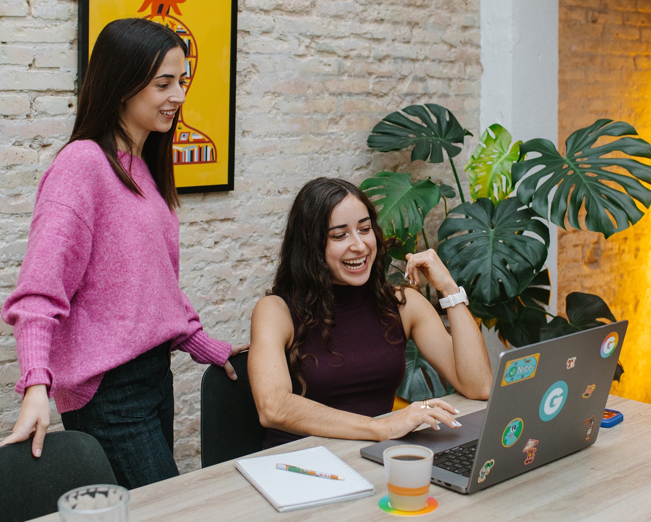 Two women discussing work at the kitchen table