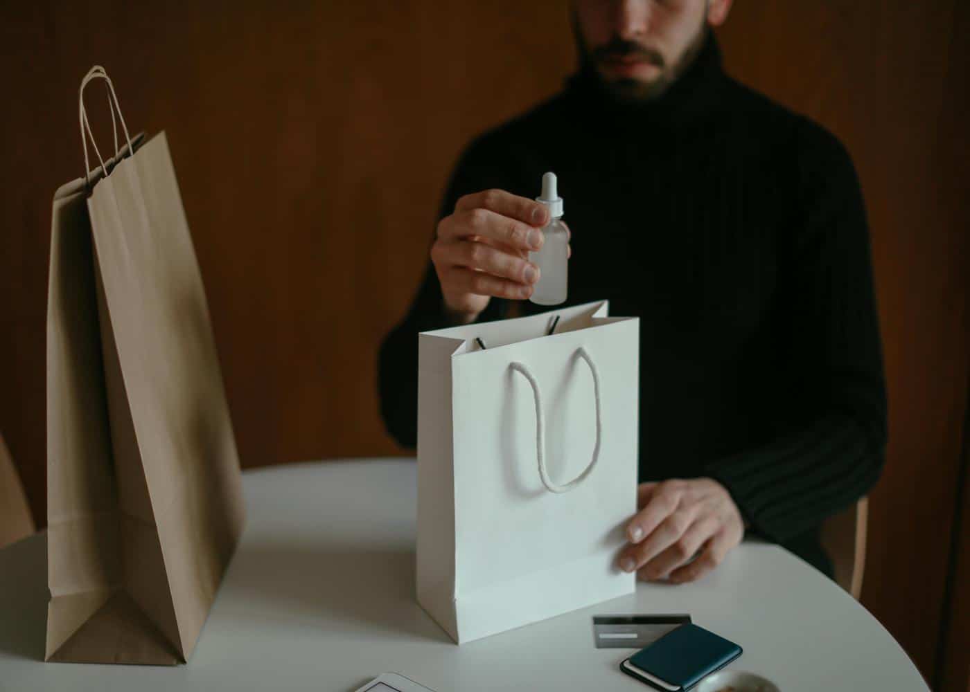 Best Beard supplements - Man taking beard oil out of a gift bag