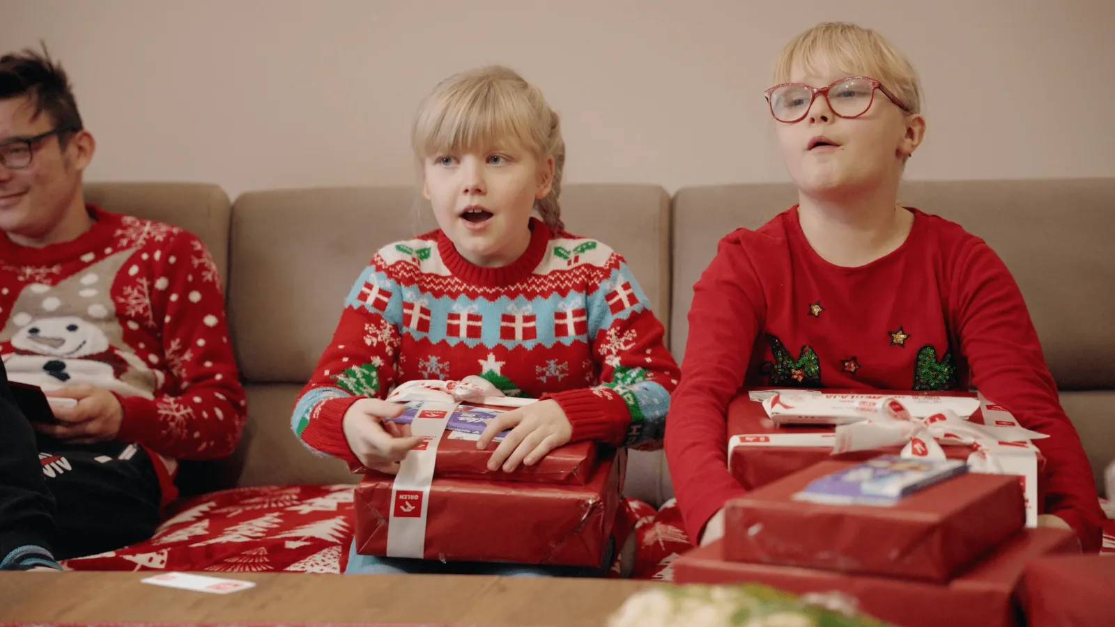 ORLEN Foundation CSR initiative, children opening Christmas parcels