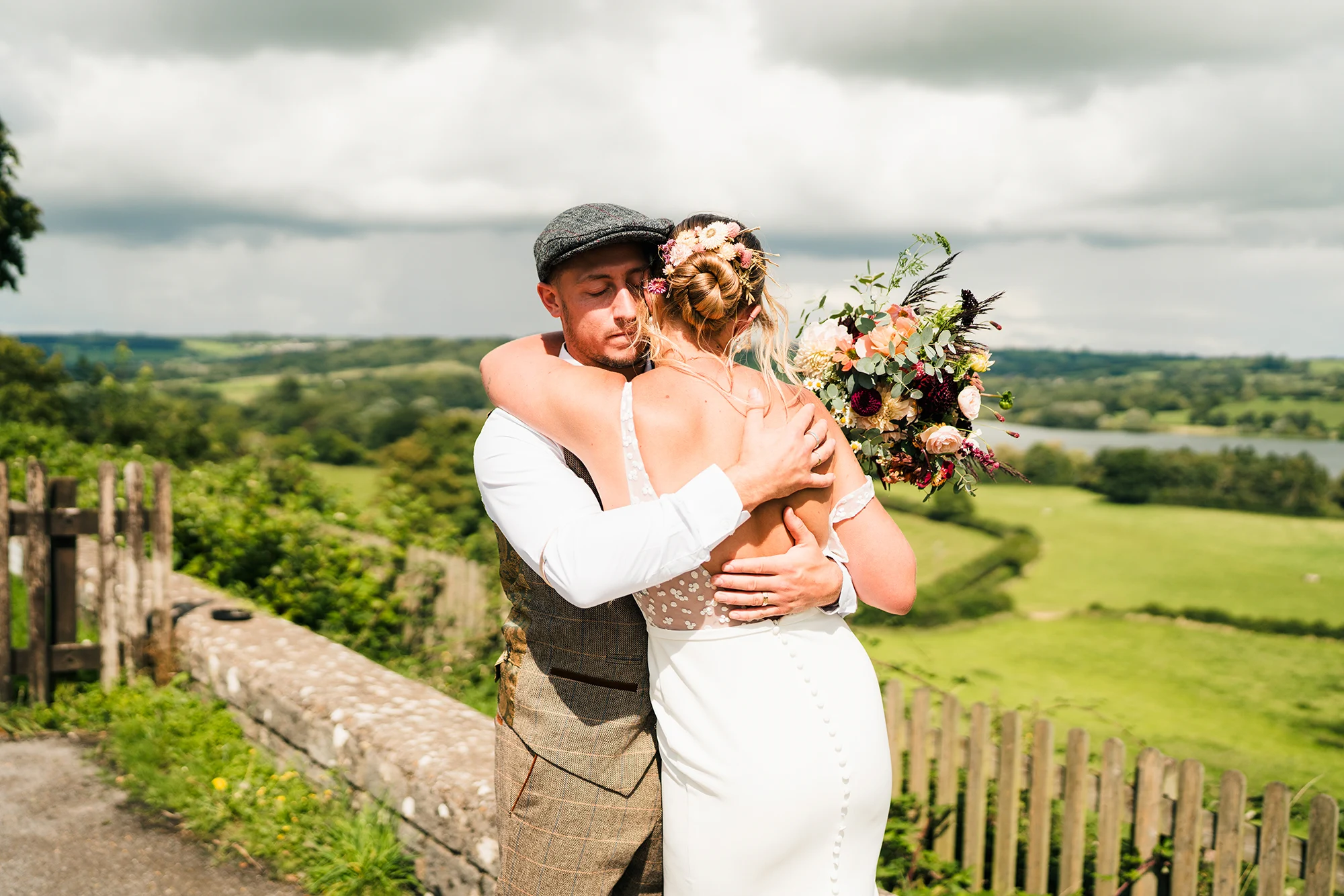 Groom hugging bride