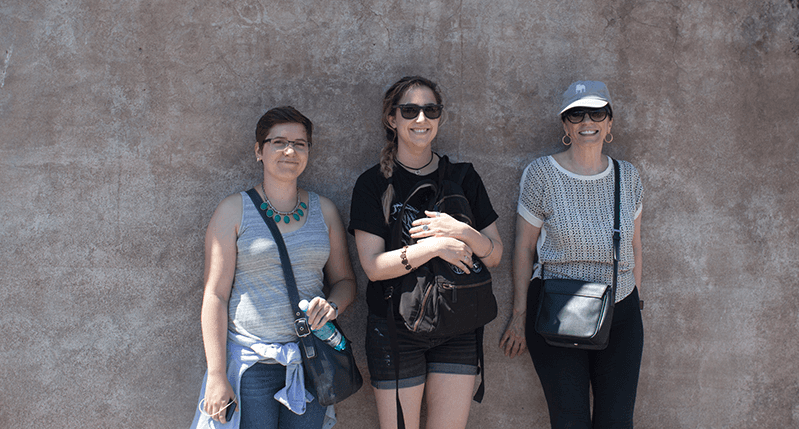 three women on wall