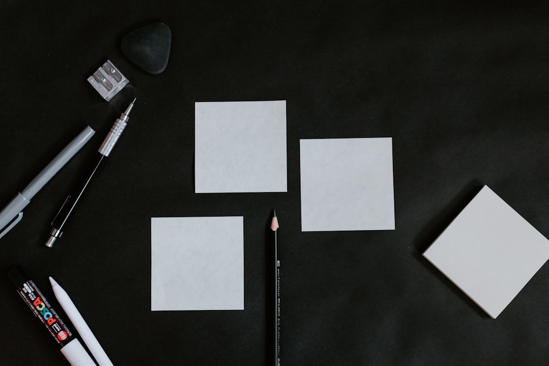 A black table topped with white cards and a pencil
