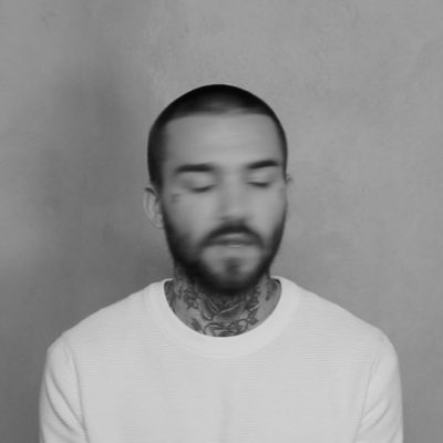 Photo of a man with dark short hair and beard.