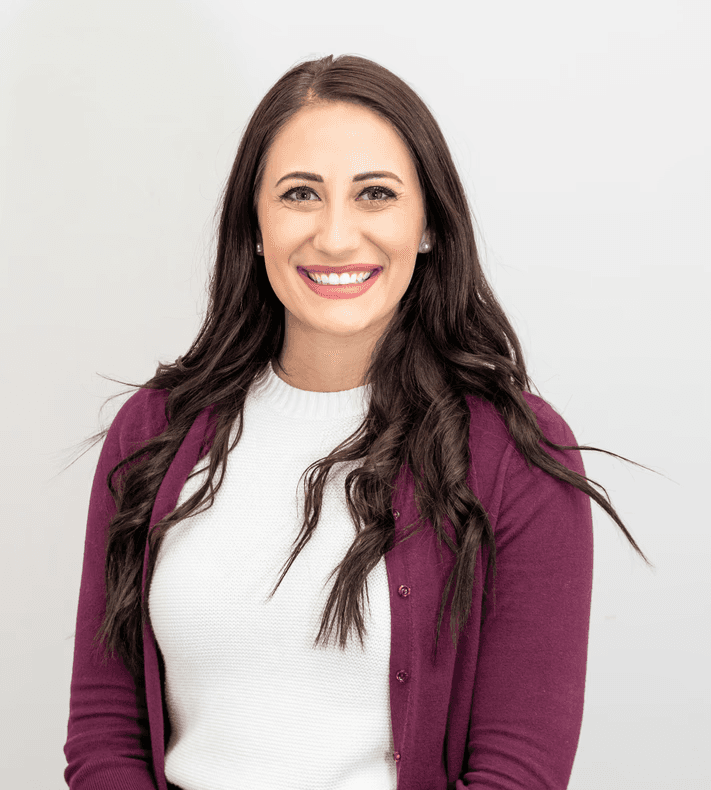 woman in red cardigan smiling
