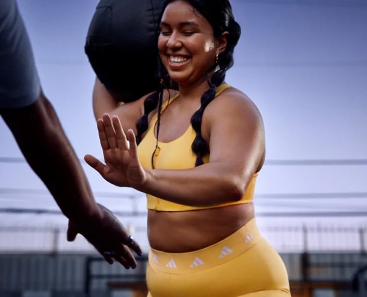 two smiling women doing yoga pose