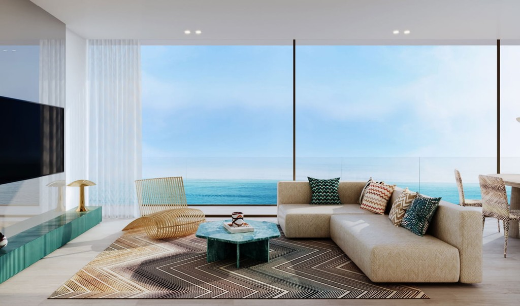 Bright living room with wooden flooring and a large window, showcasing the Trio Isle by Durar interior design.