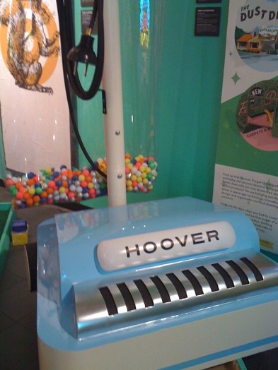a blue device with a metal part on it and a the HOOVER word written on it