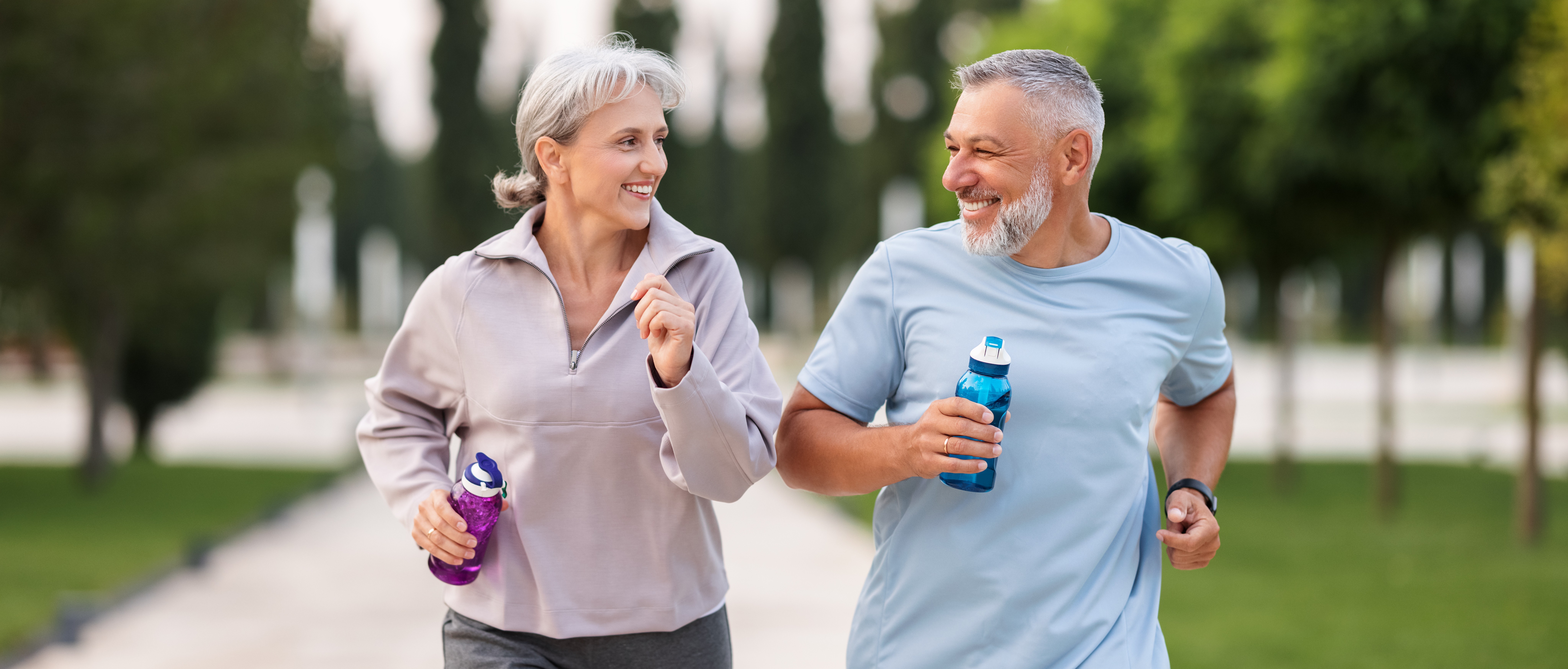 Adult couple running outdoors together as part of an active lifestyle.