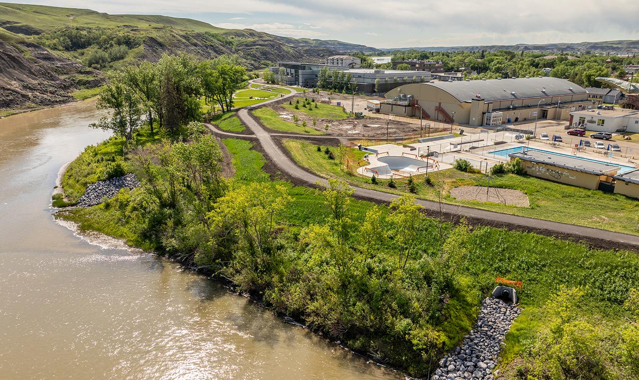 Completed Drumheller dike with riprap erosion protection and multi-use pathway protecting downtown along Red Deer River