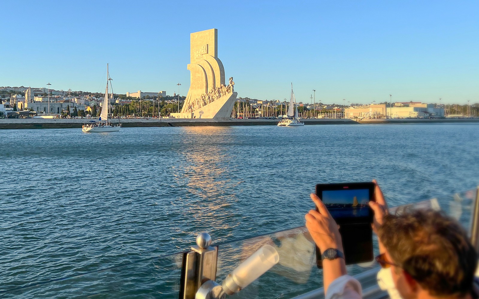 Sailboats near the Discoveries Monument on a Tagus River cruise in Lisbon.
