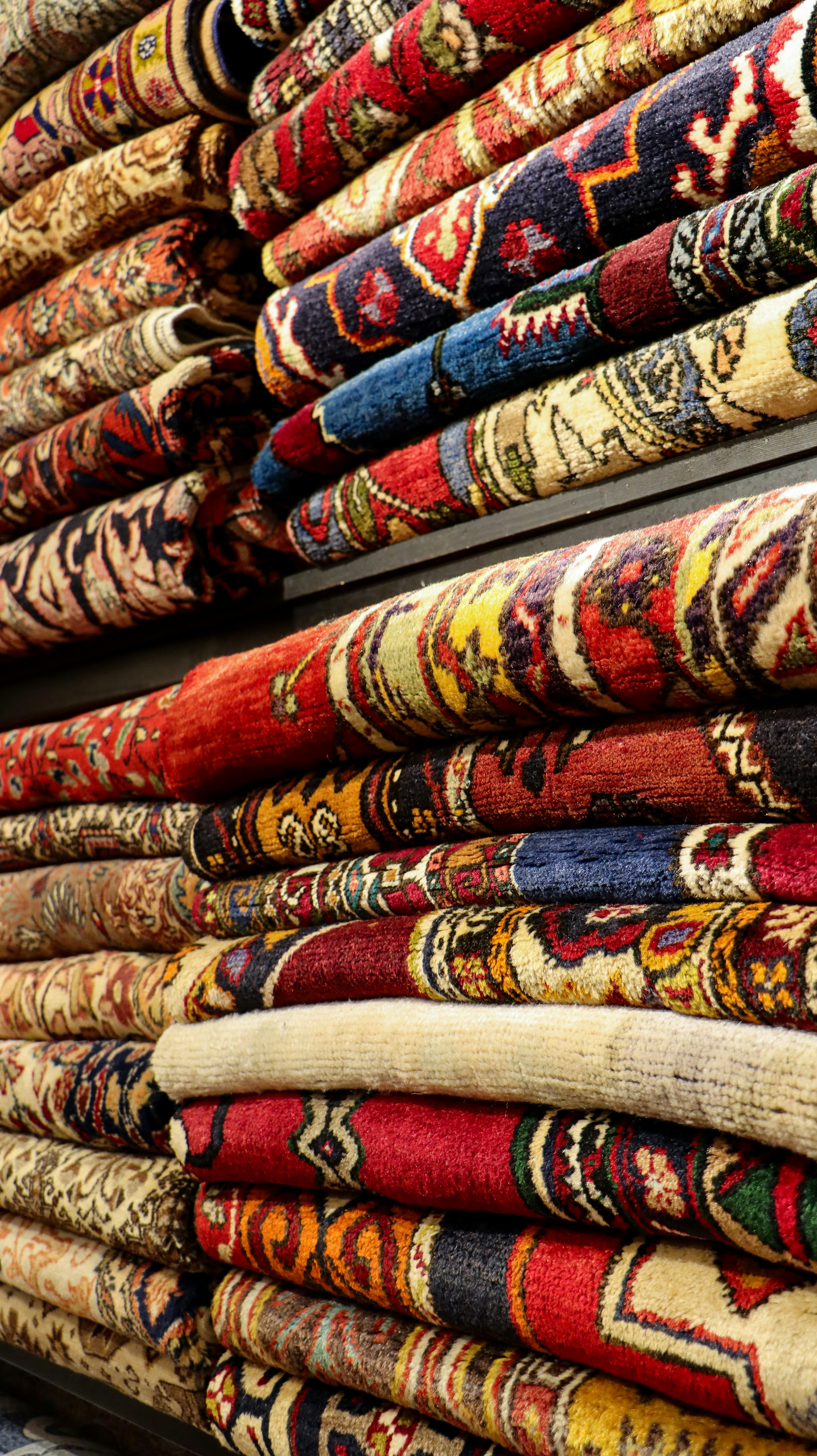 a pile of rugs are stacked on top of each other