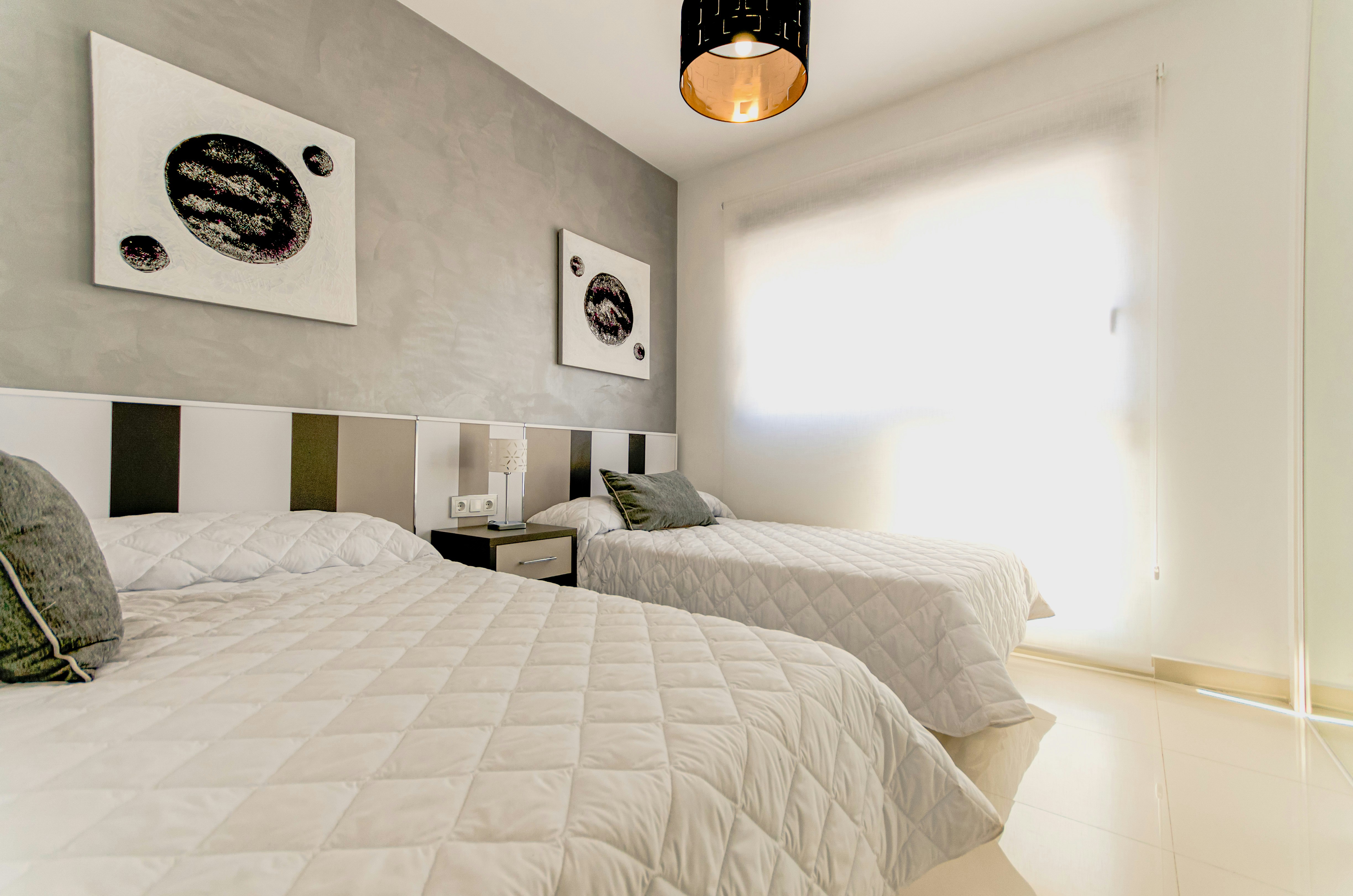 Bedroom with a modern design and statement artwork.