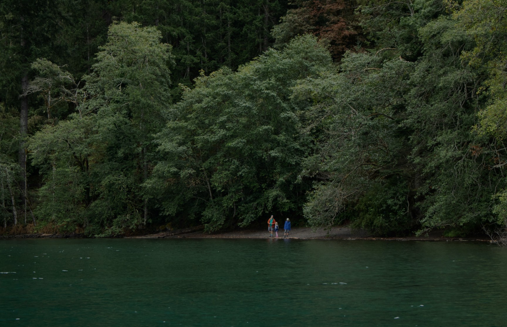 Family stands by a beautiful lake