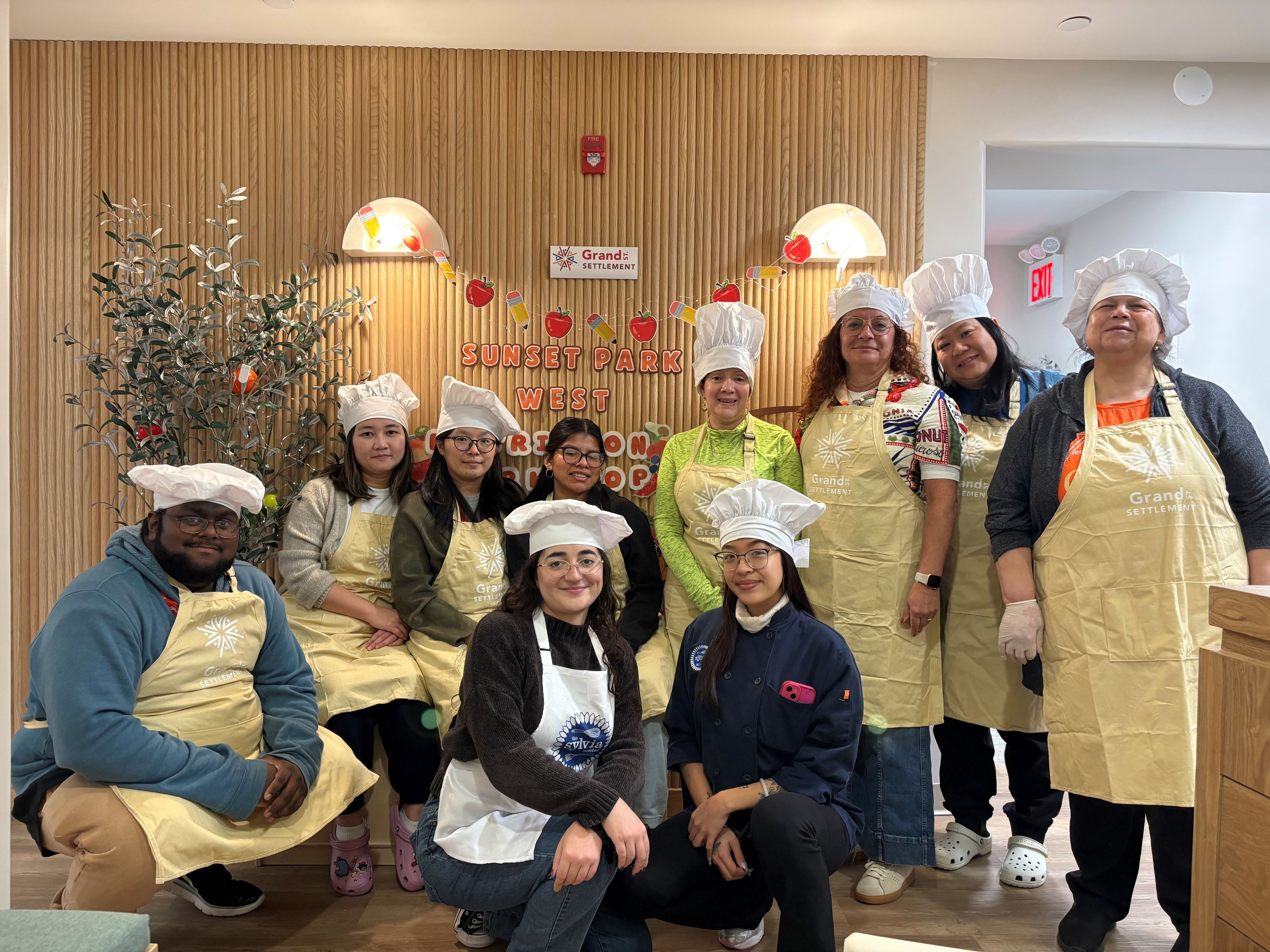 Sylvia Center partners in aprons and chefs' hats.