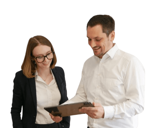A man wearing a white shirt is smiling while holding a tablet displaying colorful graphs and charts, indicating the analysis of data or business performance.