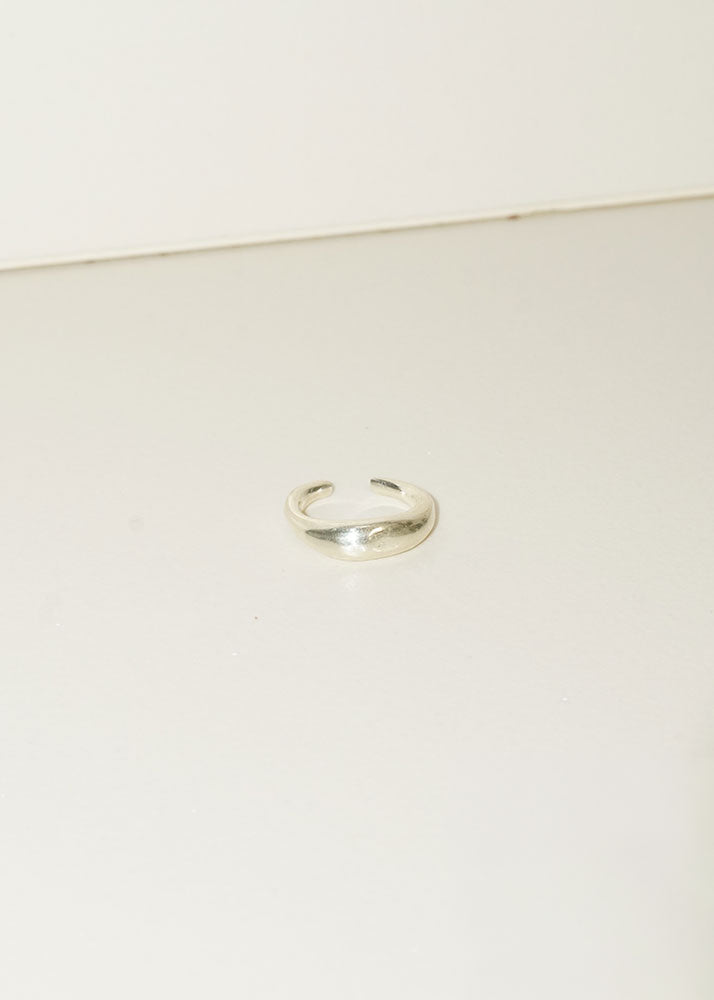 Silver ring on a light beige background