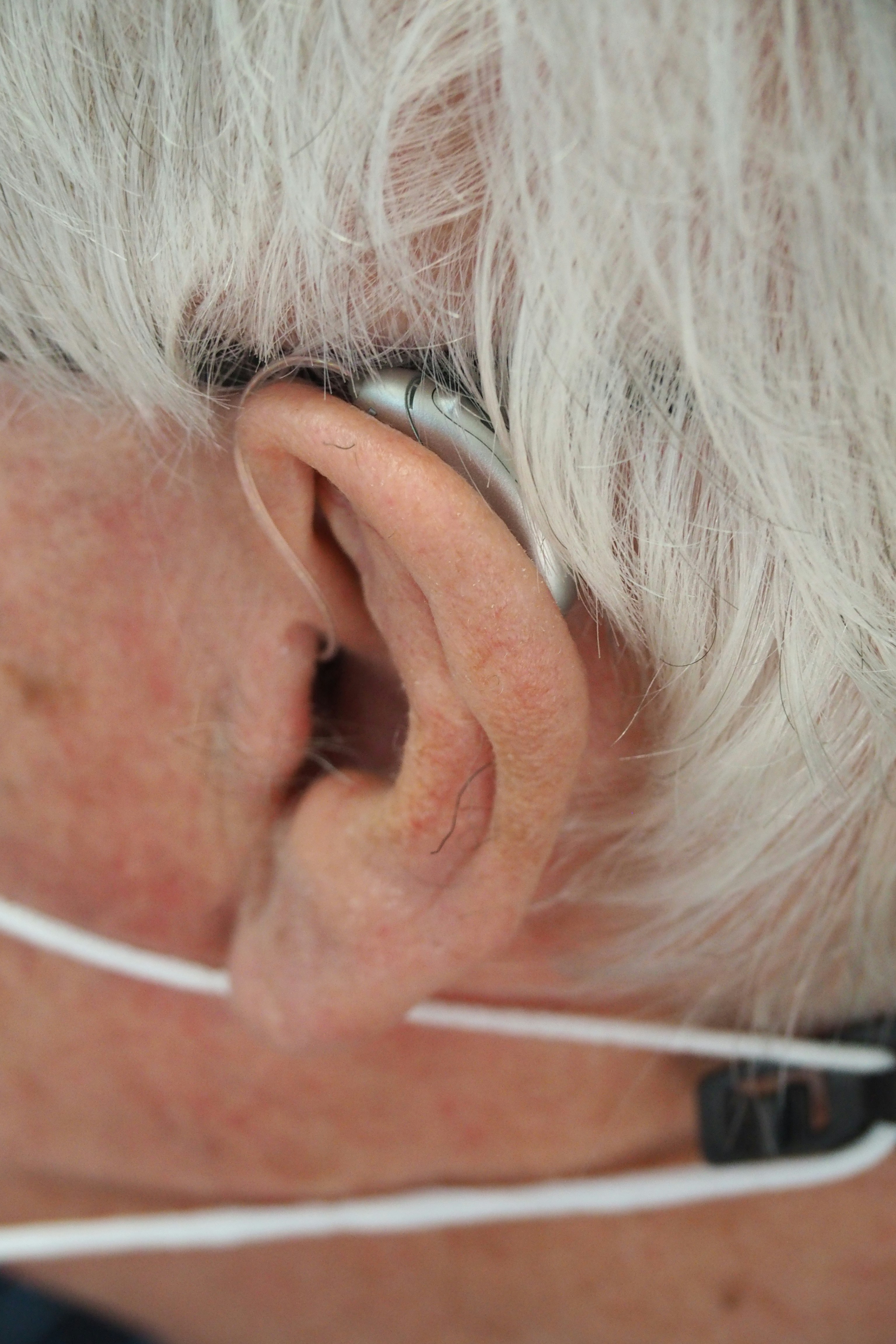 a close up of a person wearing a pair of ear phones