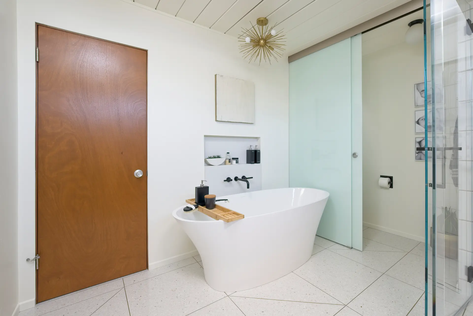 Wide view of the primary bathroom, showcasing the free-standing tub, flooring, and overall layout in the Fairhaven Eichler Tract remodel. Photo by Todd Huge.