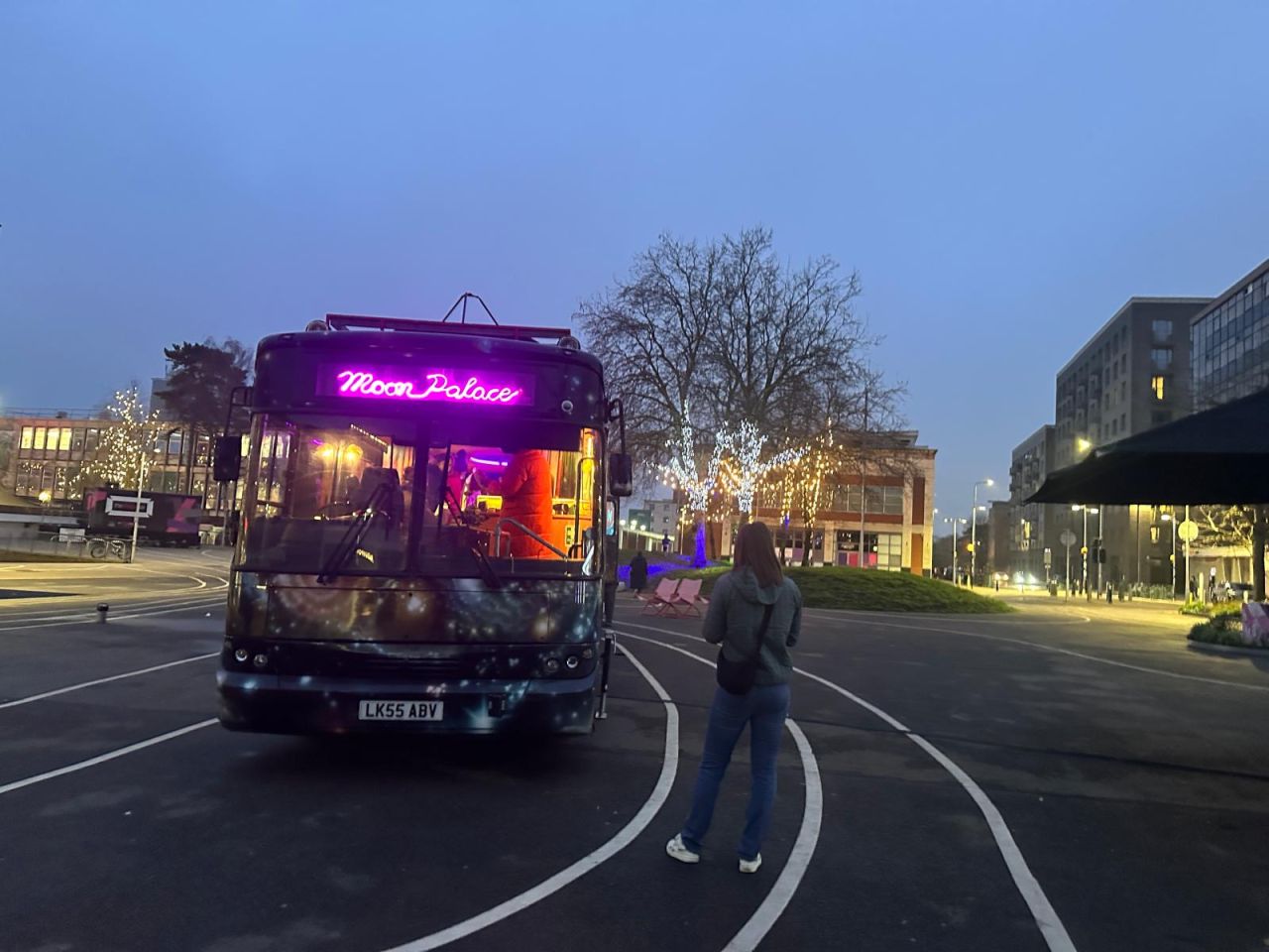 The Moon Palace bus parked at Stevenage Event Island in the evening with neon lights