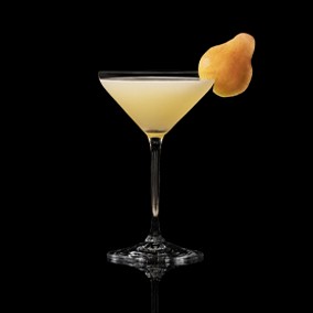 A closeup of a Pear Martini drink against a dark background.