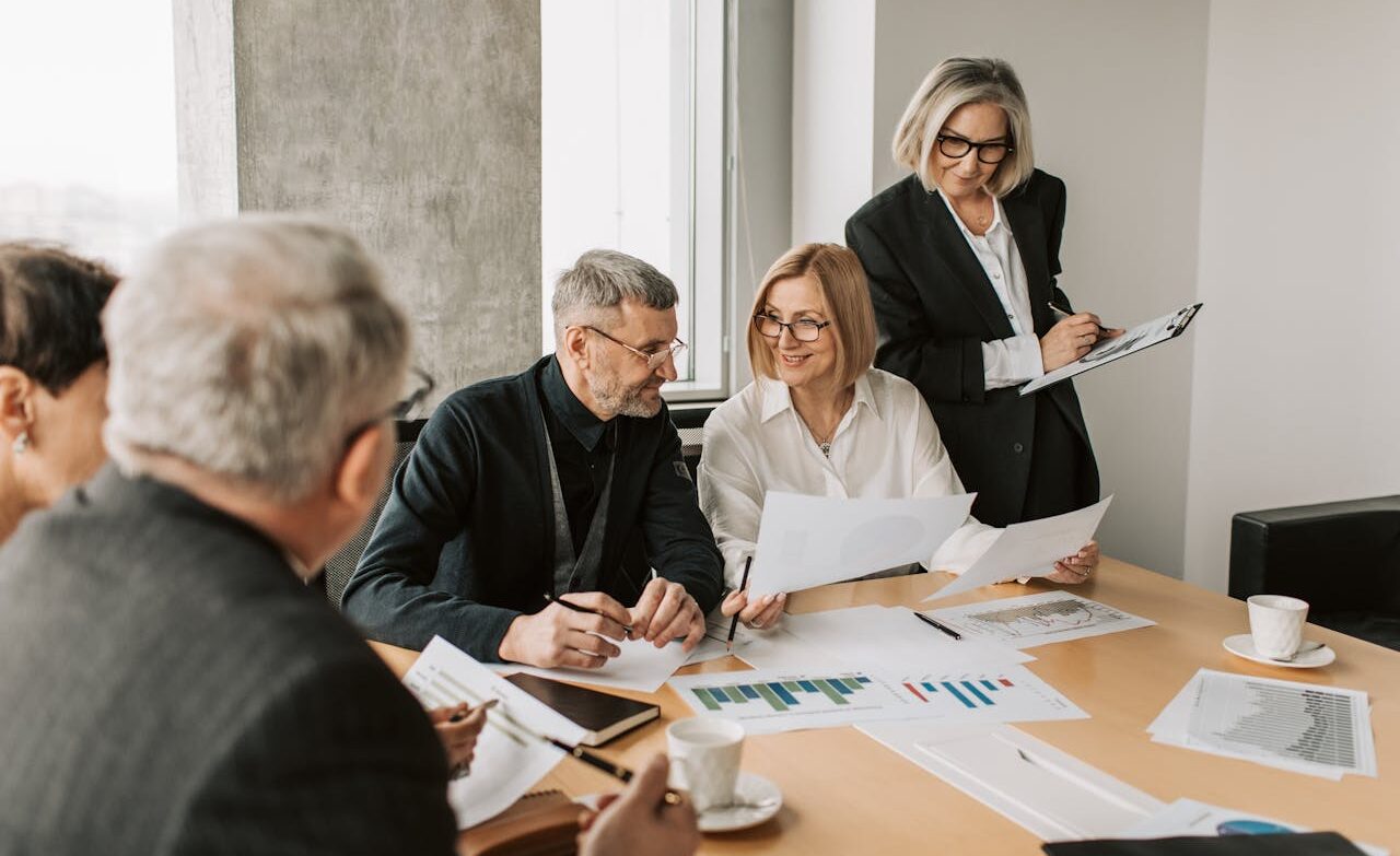Close-up of a dark green leaf showing its textured surface and central vein against a muted background.