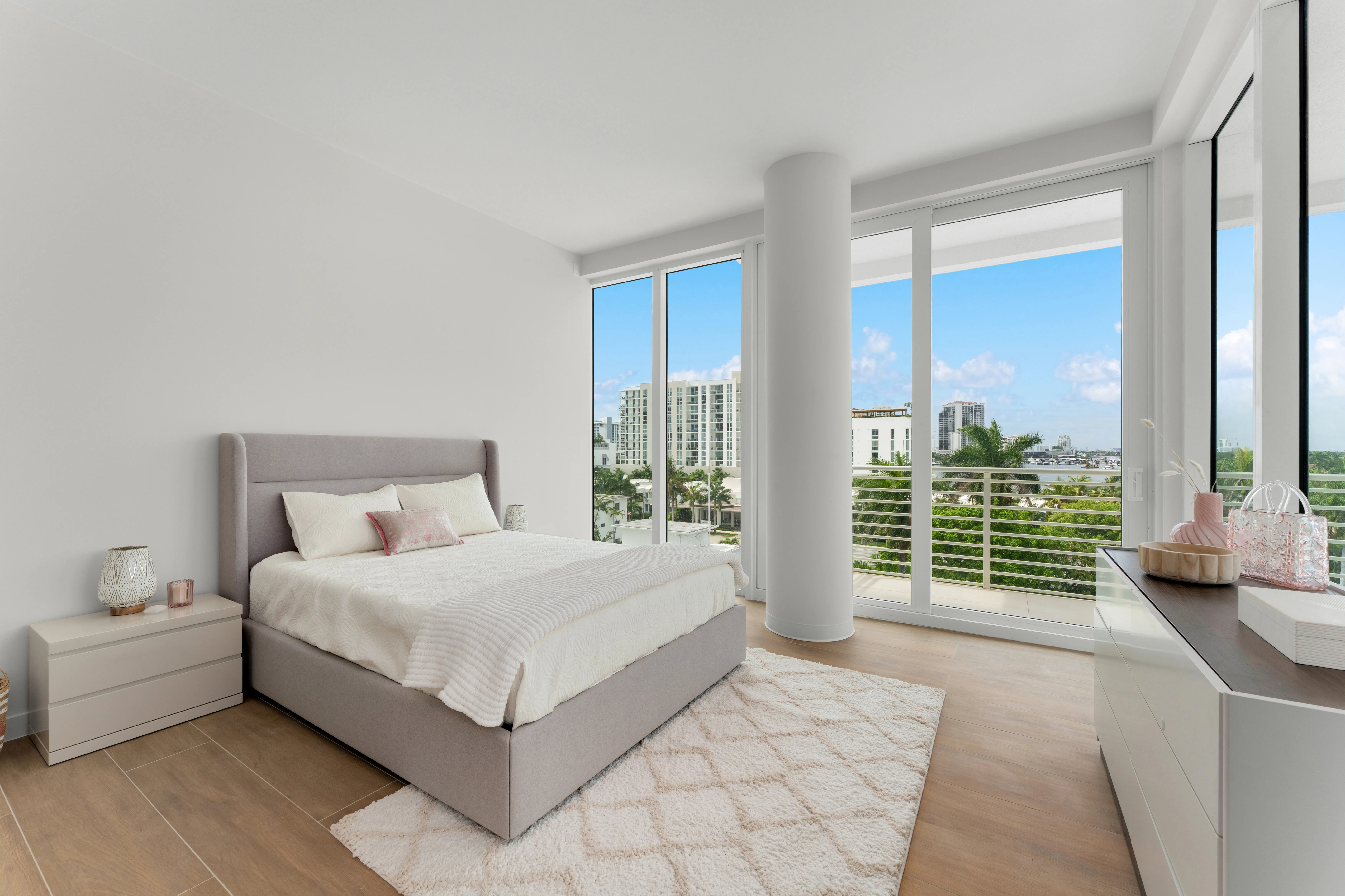 A sleek modern bedroom with a comfortable bed and a minimalist sink, highlighting a blend of functionality and style.