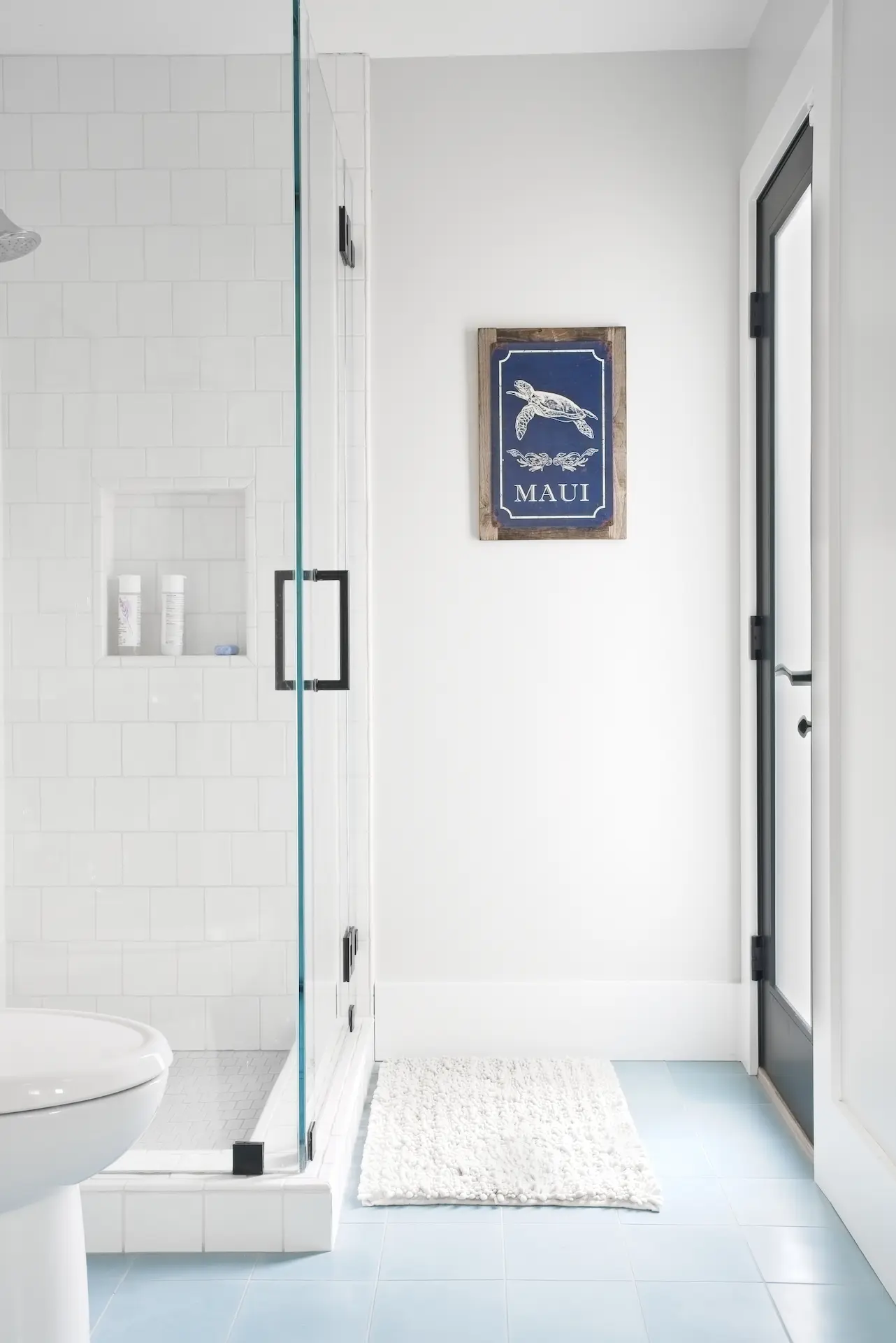 Minimalist bathroom with glass shower and nautical decor in North Tustin Remodel & Addition. Photo by Todd Huge.