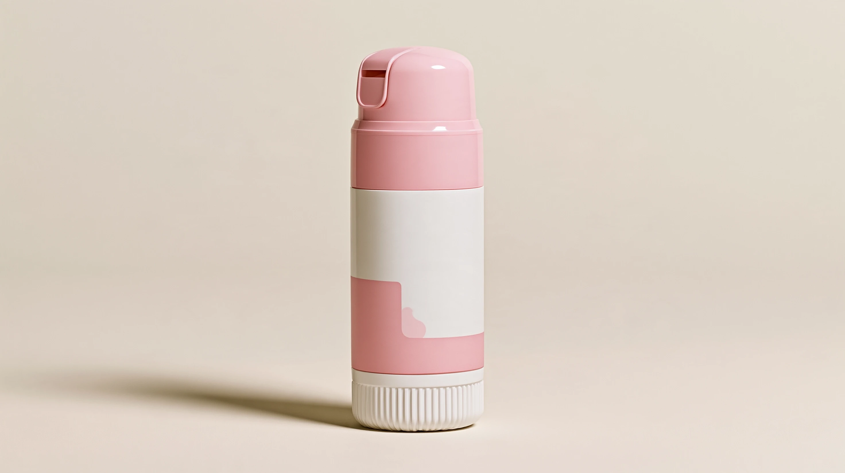 Upright pink-and-white bottle with a rounded pink cap and ribbed white base on a beige surface.