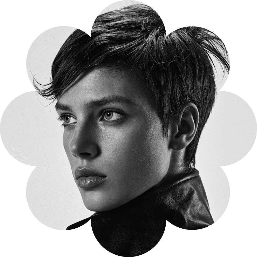 Black and white artistic portrait of a young person with short textured hair, placed inside a modern abstract flower-shaped frame, high contrast photography