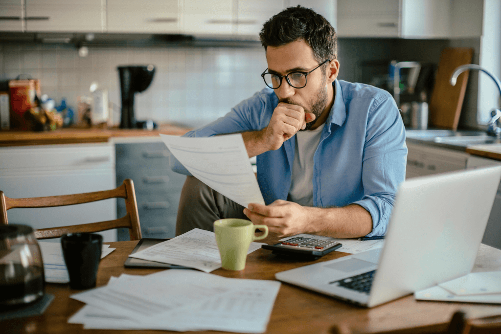 Worried young man going over his finances