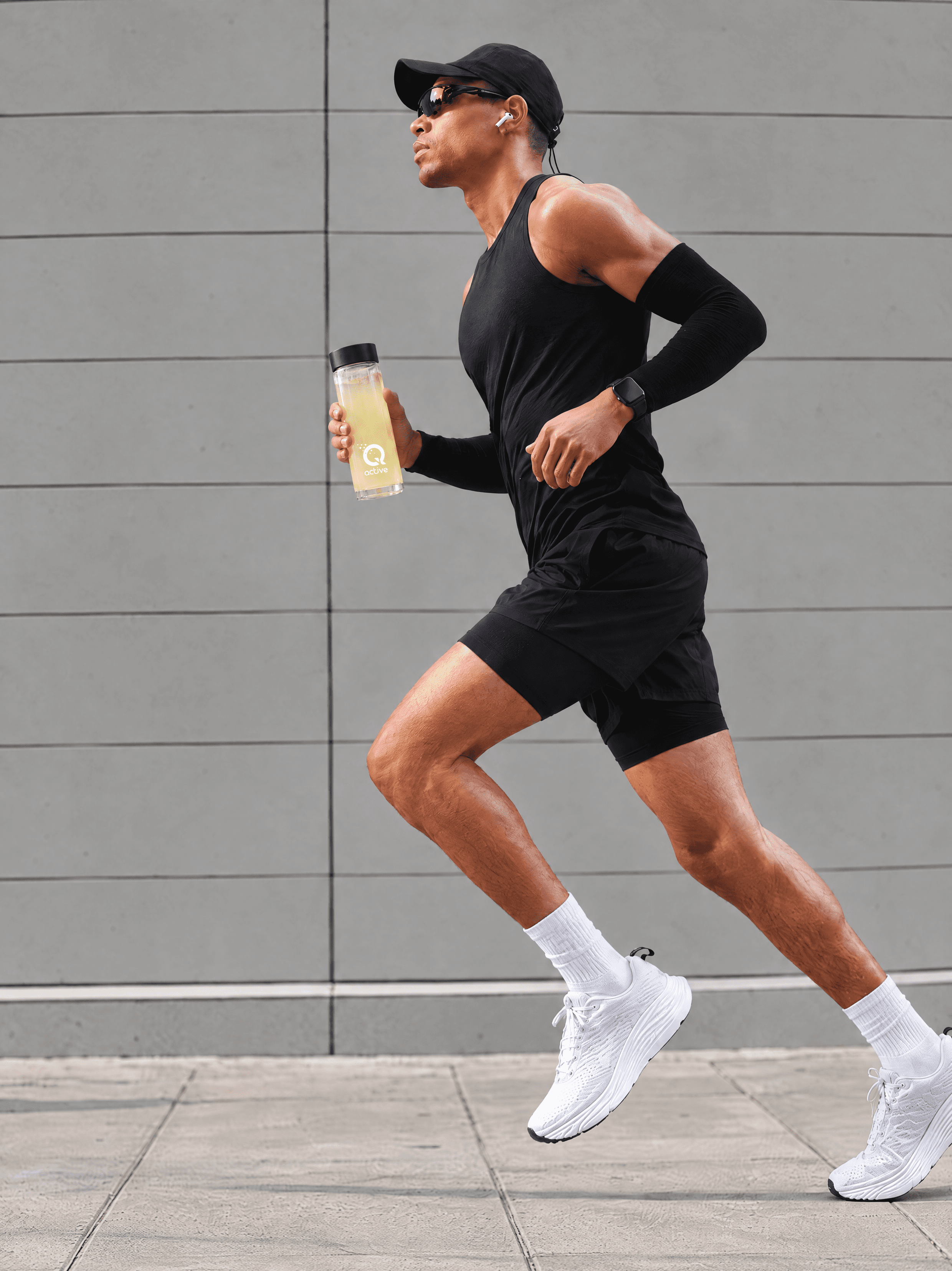 Runner holding a water bottle mixed with Q-Active liquid quercetin