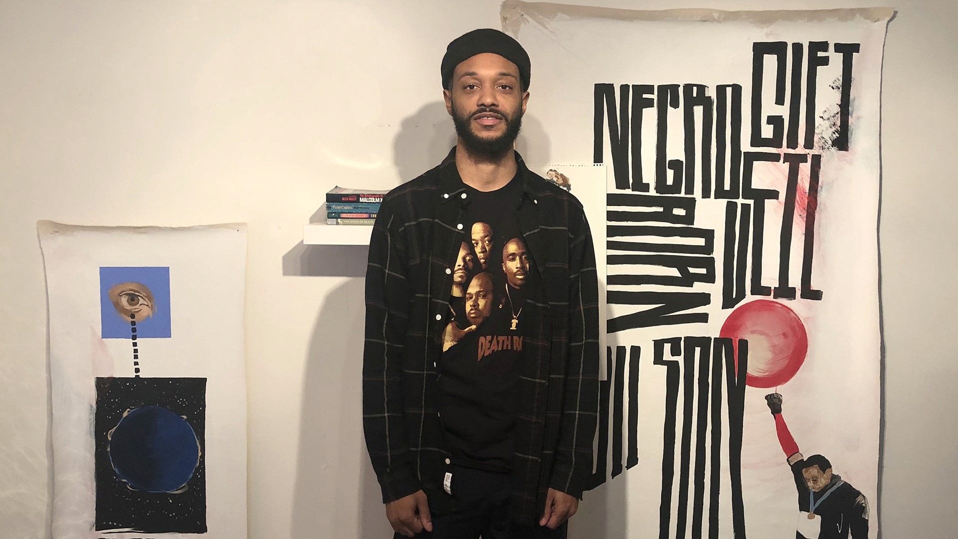 Mitchell R Johnson in front of typography painting piece