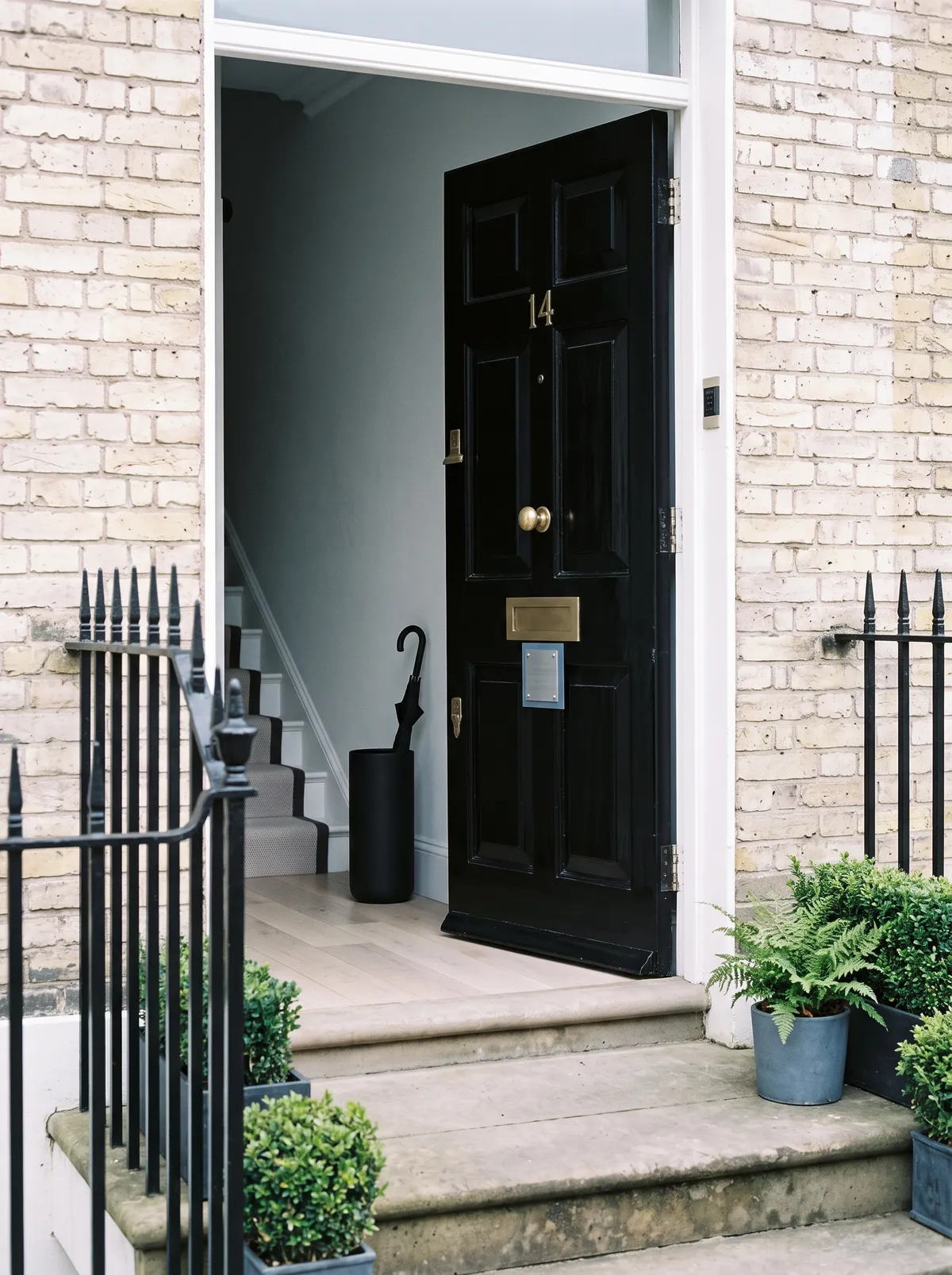 The black front door and brass plate of the Richmond office, a Georgian townhouse