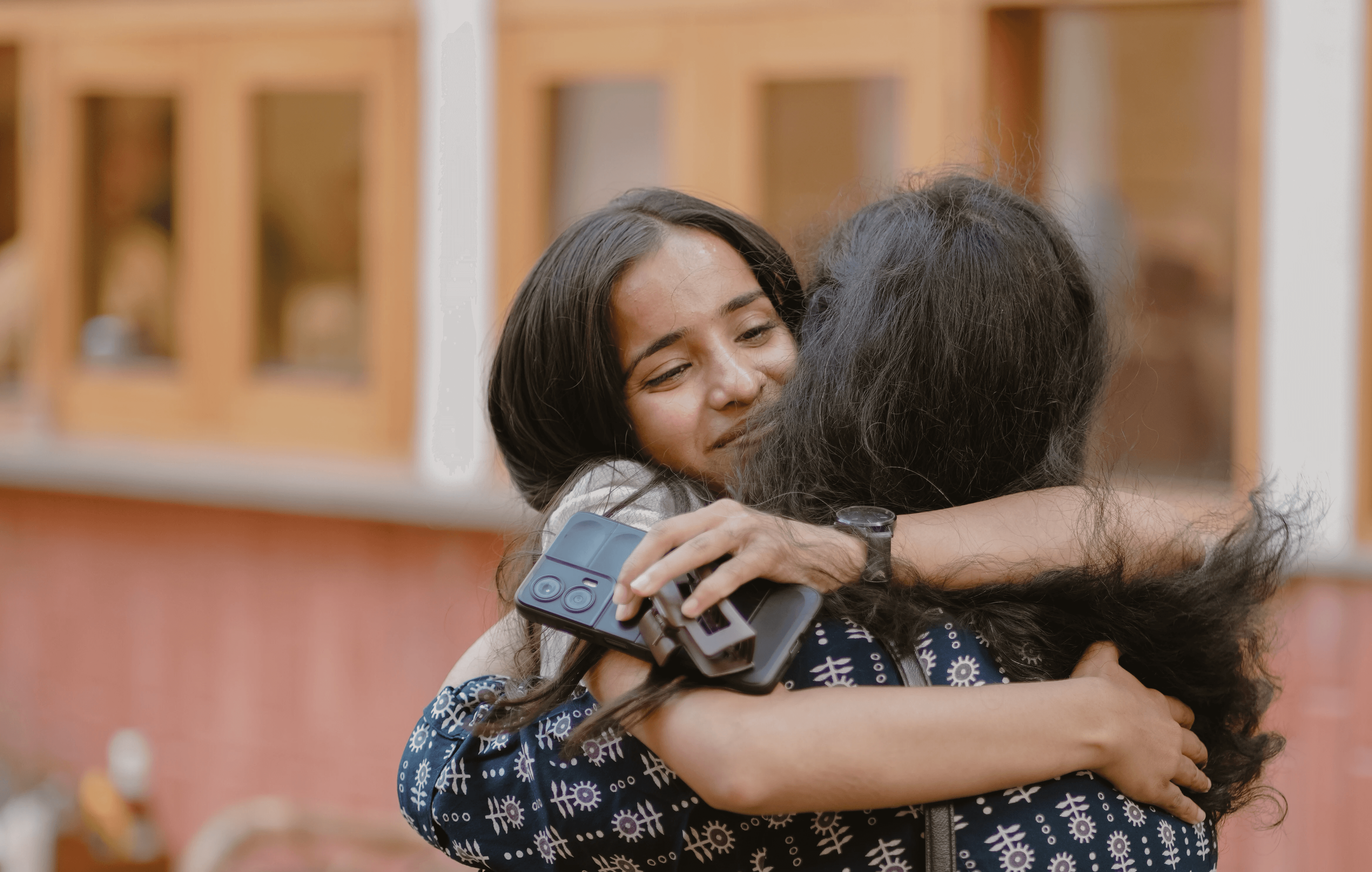 Two women hugging closely.