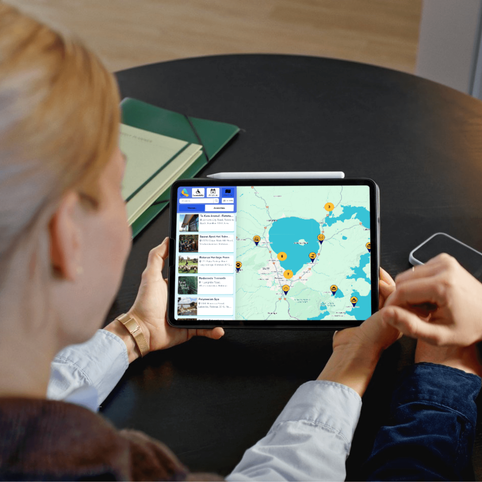 A woman holdina tablet displaying an access map