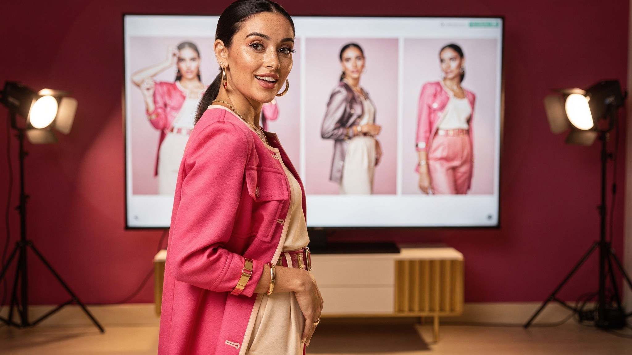 Creator reviewing multiple polished photos of herself on a large screen