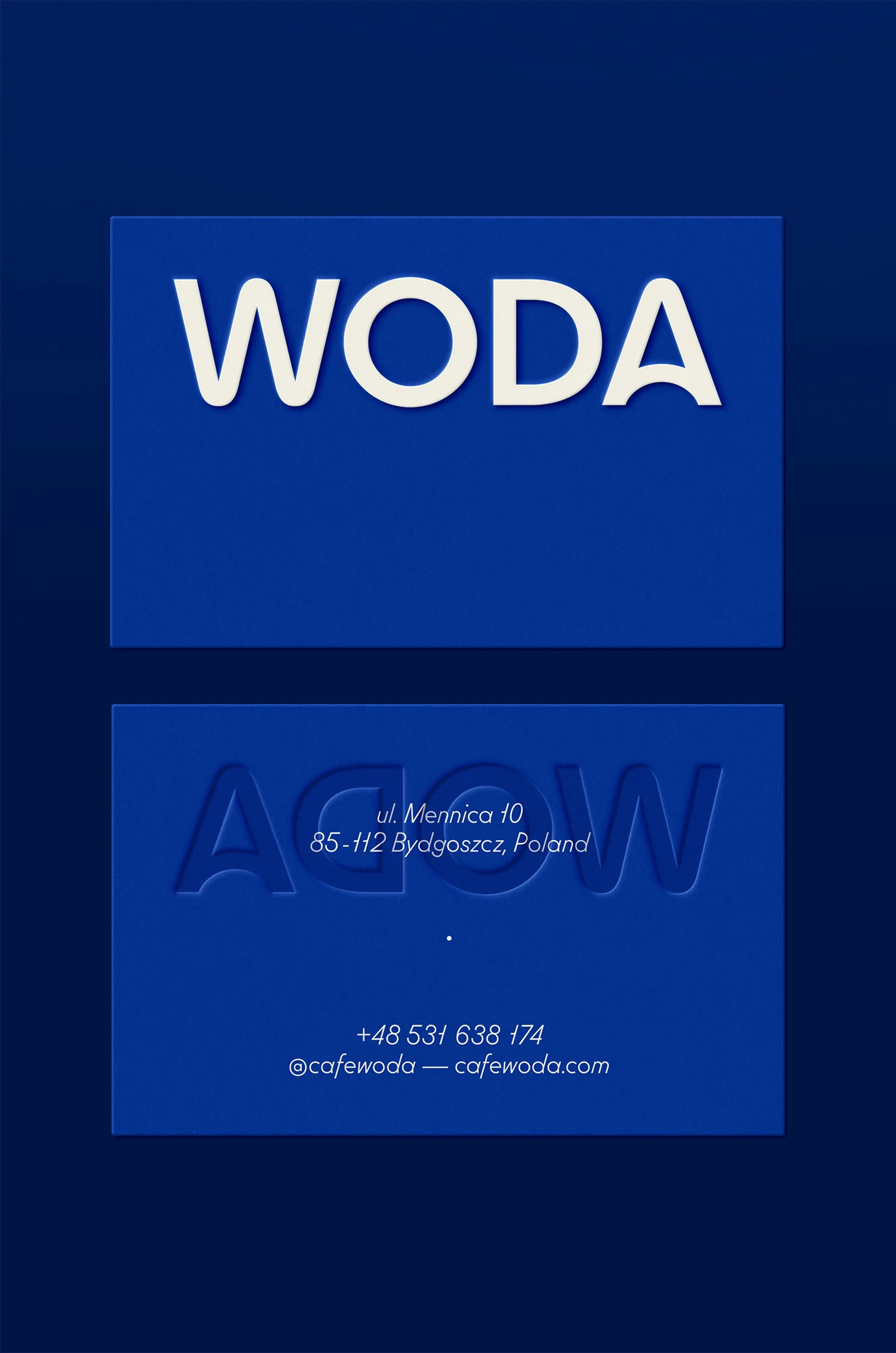 Woda business cards in cobalt blue with embossed logotype and Bydgoszcz address, restaurant stationery design