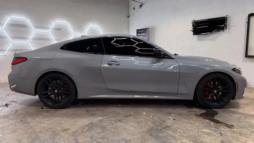 side of a gray car with tinited windows