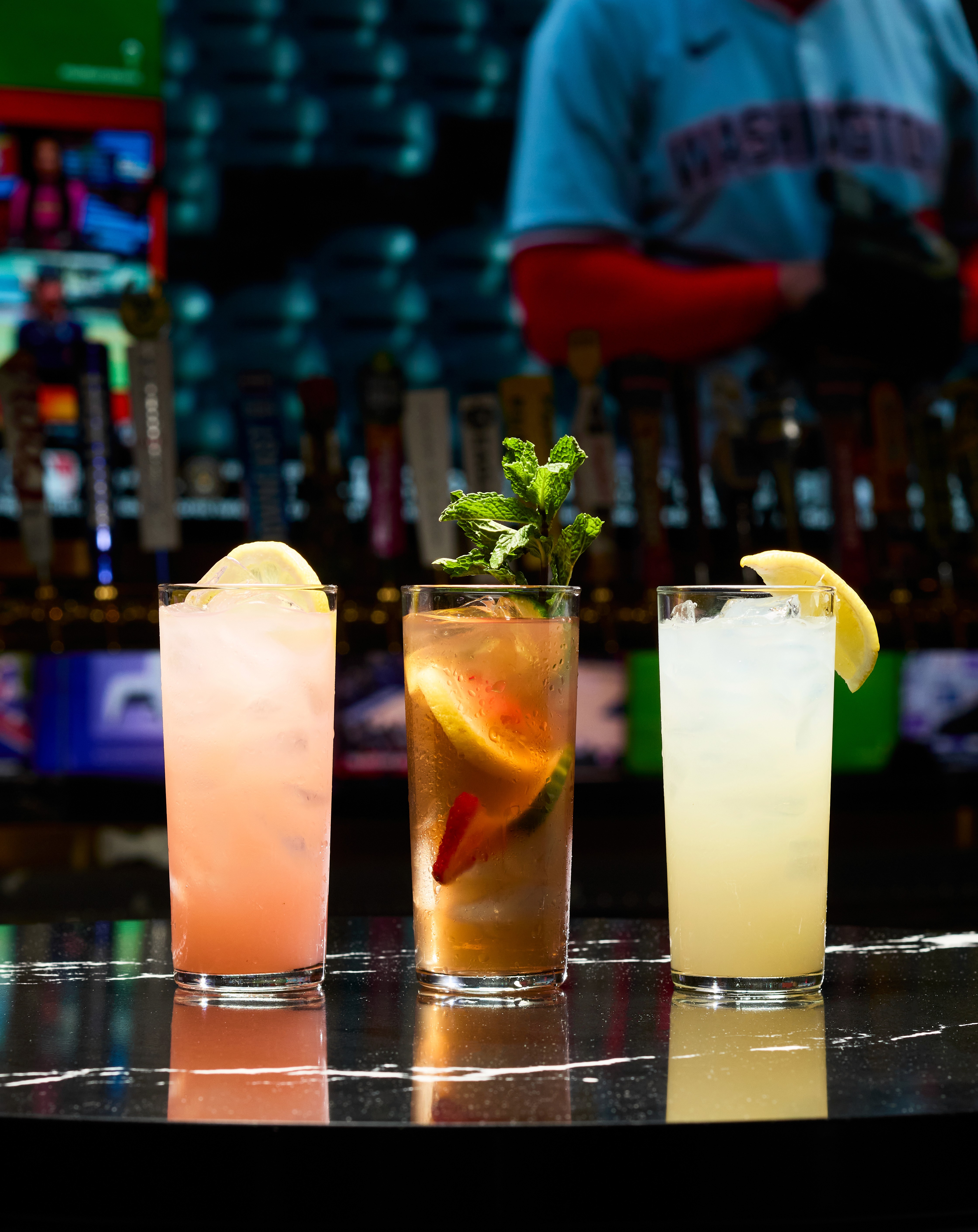Three cocktails against a screen