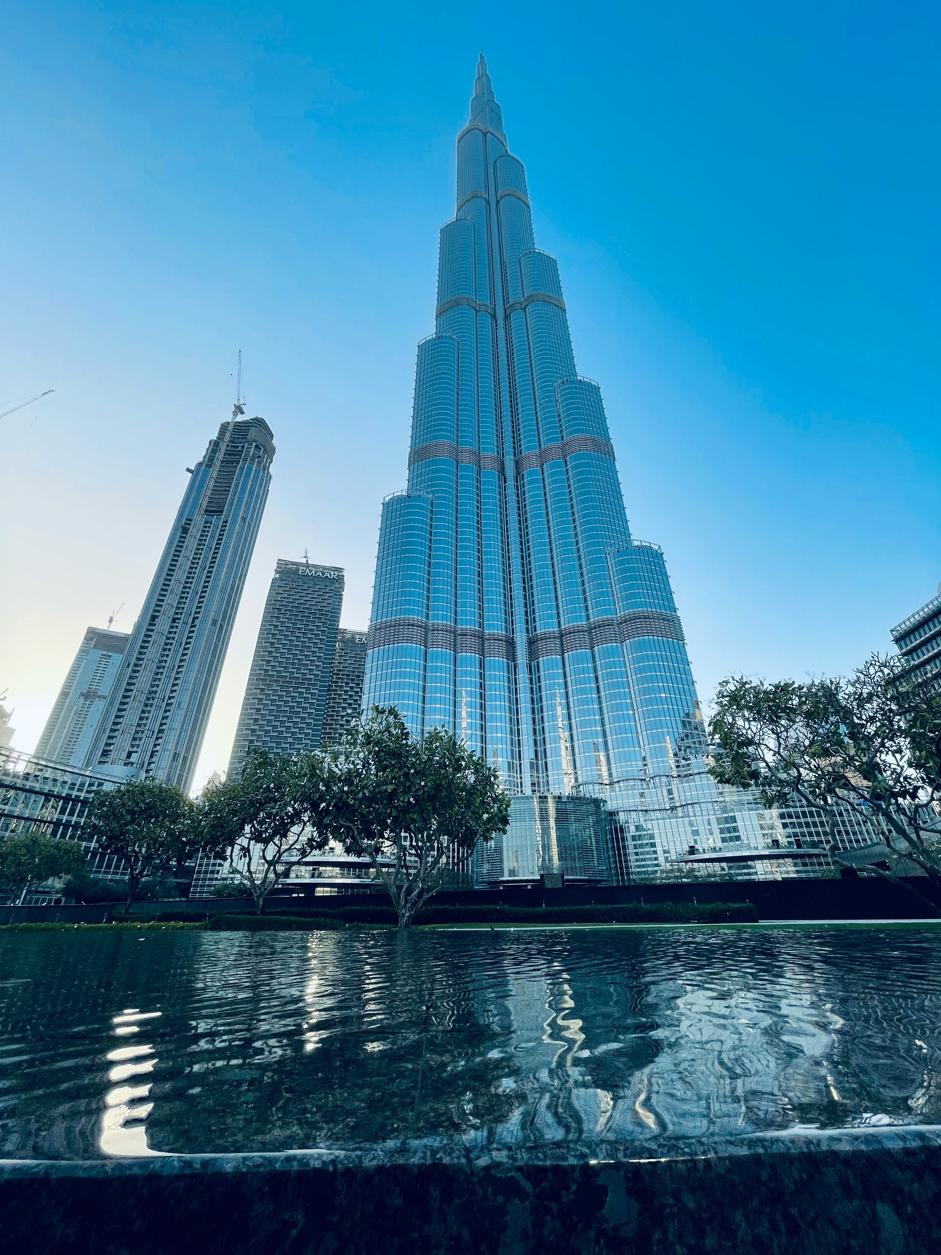 a very tall building towering over a body of water