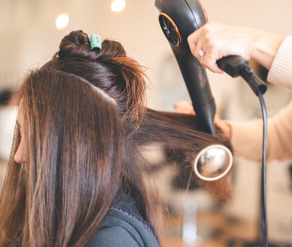Client blowout session of Del Sol Hair Studio salon floor in Huntington Beach