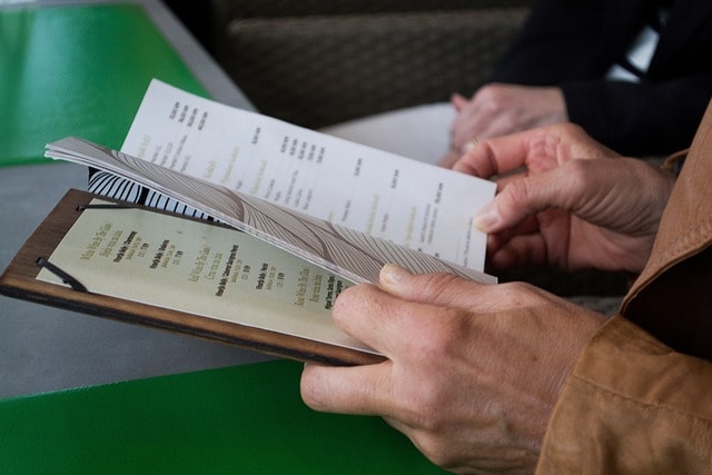 Hands holding a menu